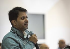 Customer asking question in microphone standing