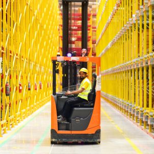 DHL employee on forklift in DHL warehouse in India