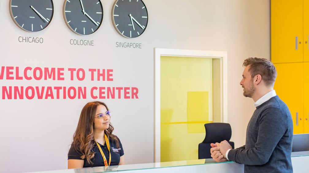 A DHL employee talking to a client in the innovation center.