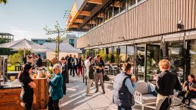 DHL customers socialize on sunny outdoor terrace