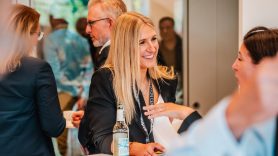 Two women network and smile at DHL event