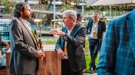 Two men network outside of DHL Innovation Center
