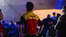 Man wearing DHL t-shirt facing away from camera