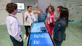 Delegates talk in the sustainability zone at Now & Next