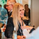Two women network and smile at DHL event