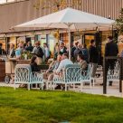Wide shot of outdoor patio area during customer event