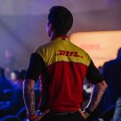 Man wearing DHL t-shirt facing away from camera