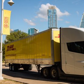 DHL lorry in front of Austin skyline