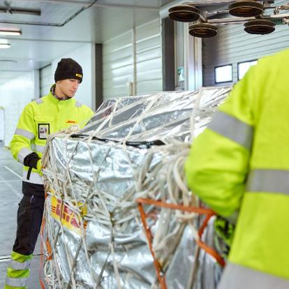 Air freight shipment being handled by DHL staff