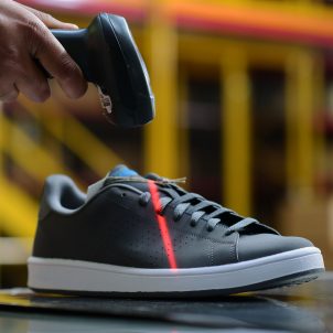 Photo of shoe being scanned in DHL warehouse