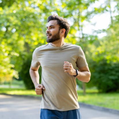 Indian man running in green park