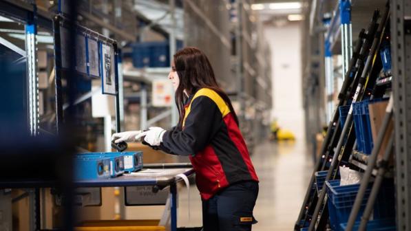 A DHL employee in a warehouse.