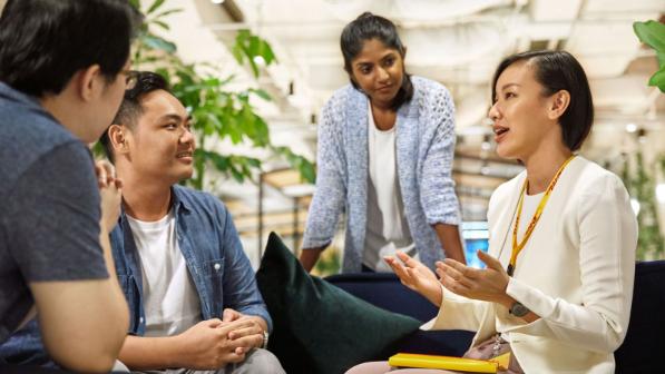 Four people having a discussion.