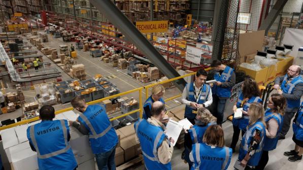 Visitors at a DHL warehouse.