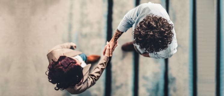 Woman and man greet each other