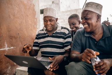 Laughing men at the computer