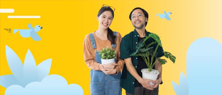 Man and woman carrying a plant with illustrated birds in the background.