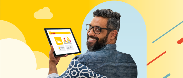 Man holding a tablet device with charts and looking at the camera.