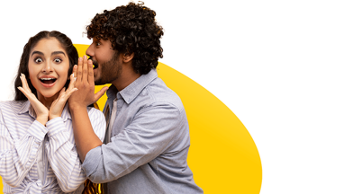 Man whispers something in woman's ear