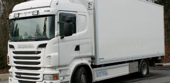 A close-up of a white Scania truck.