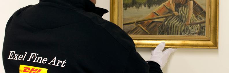 DHL Fine Art technician securing painting to a wall. 