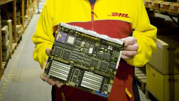 DHL warehouse worker showing a computer motherboard
