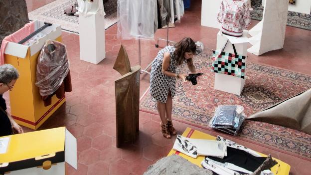 Woman photographing new deliveries in a fashion store