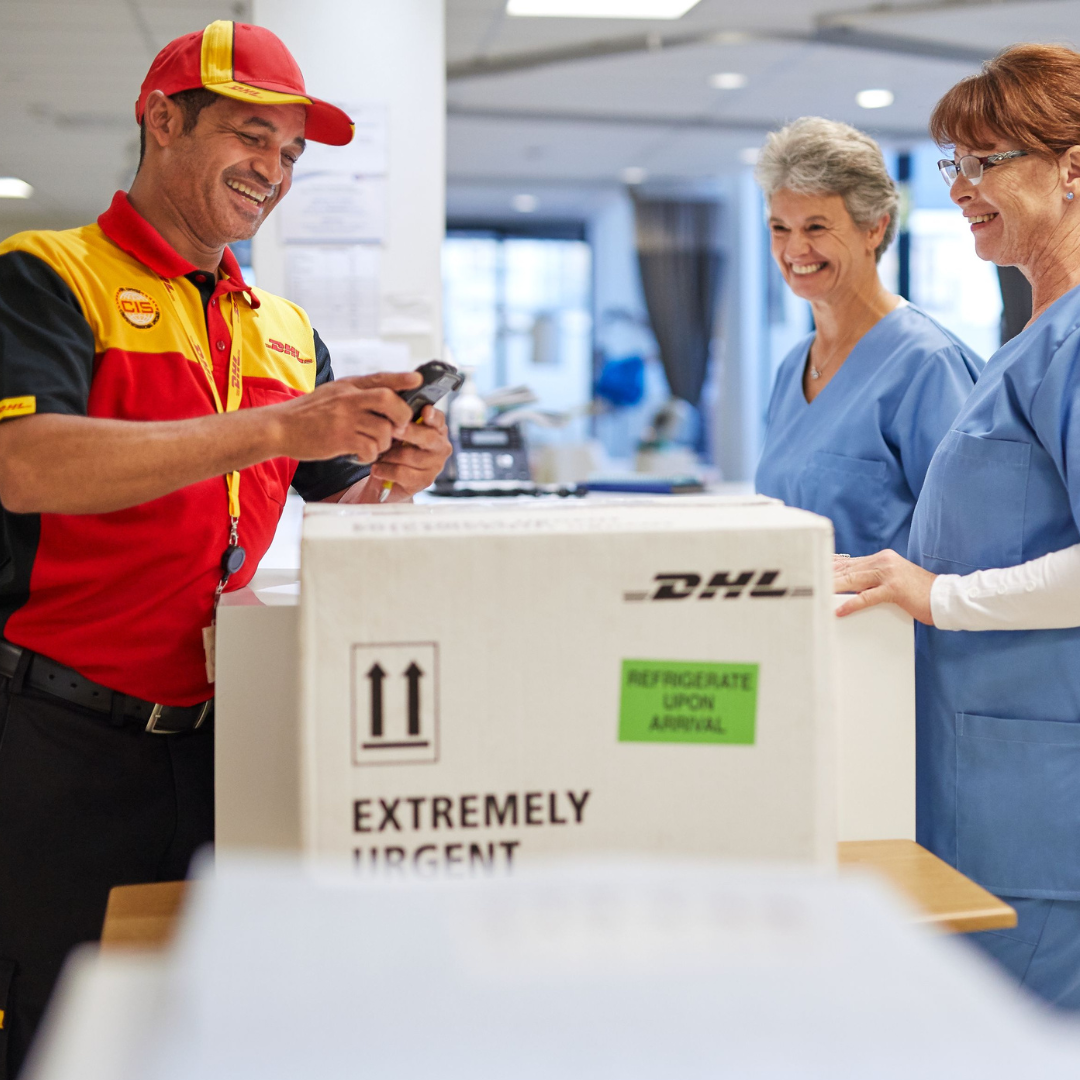 dhl employee giving parcel to customers