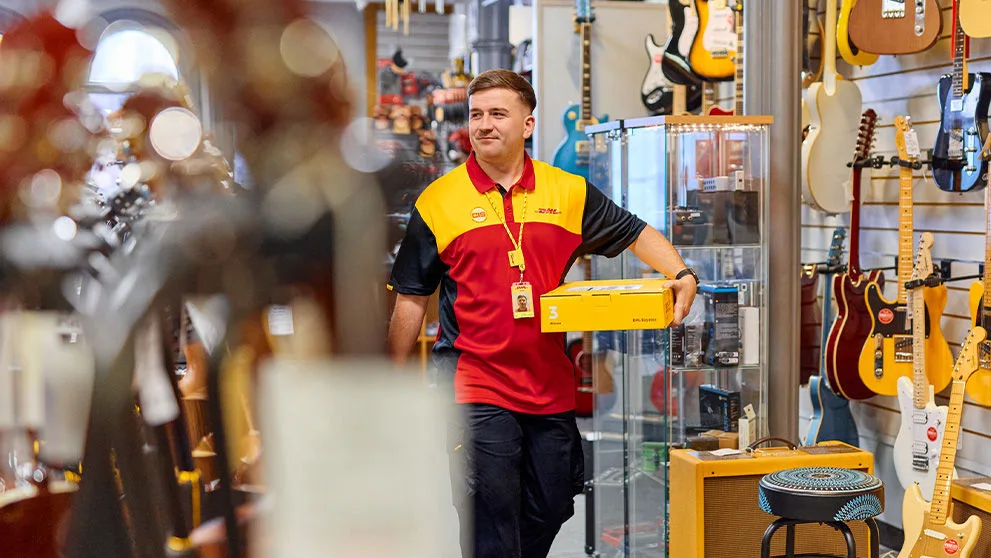 DHL courier holding a yellow box