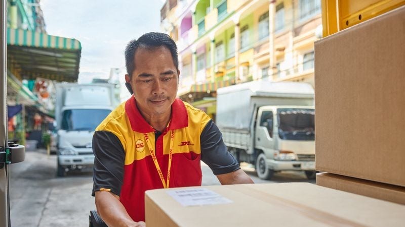 dhl employee loading parcels of durian for export to china