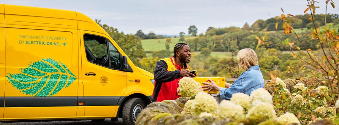 DHL courier handing a woman a parcel