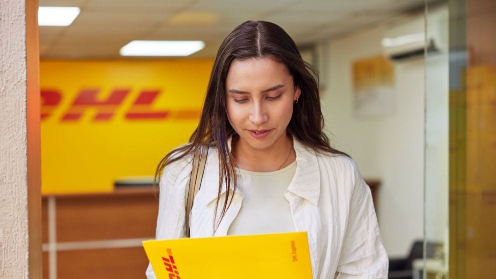 DHL Express customer with an envelope at a DHL Express Service point