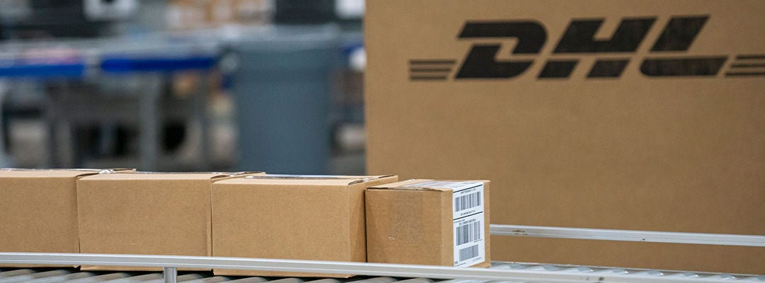 DHL sustainable packaging boxes on a conveyor belt