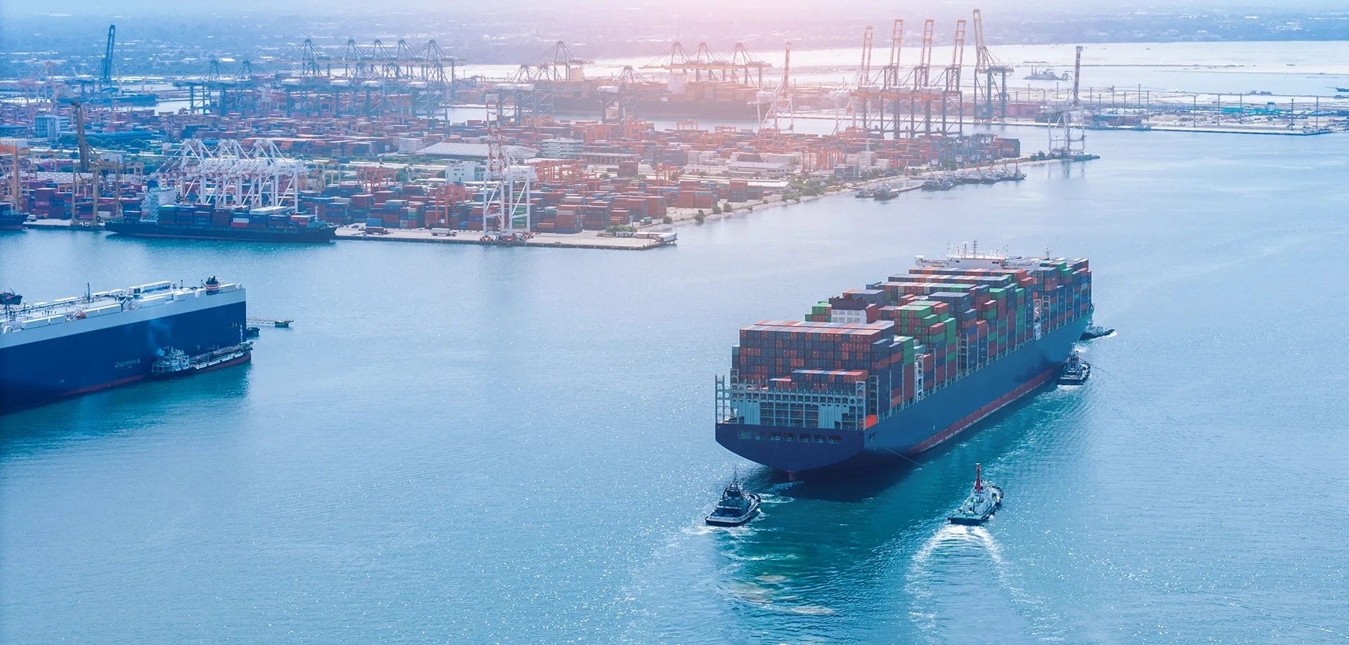 Container ship being loaded at port, the point where risk passes under the CFR Incoterm