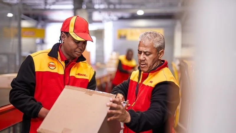 dhl express employees checking parcels for delivery