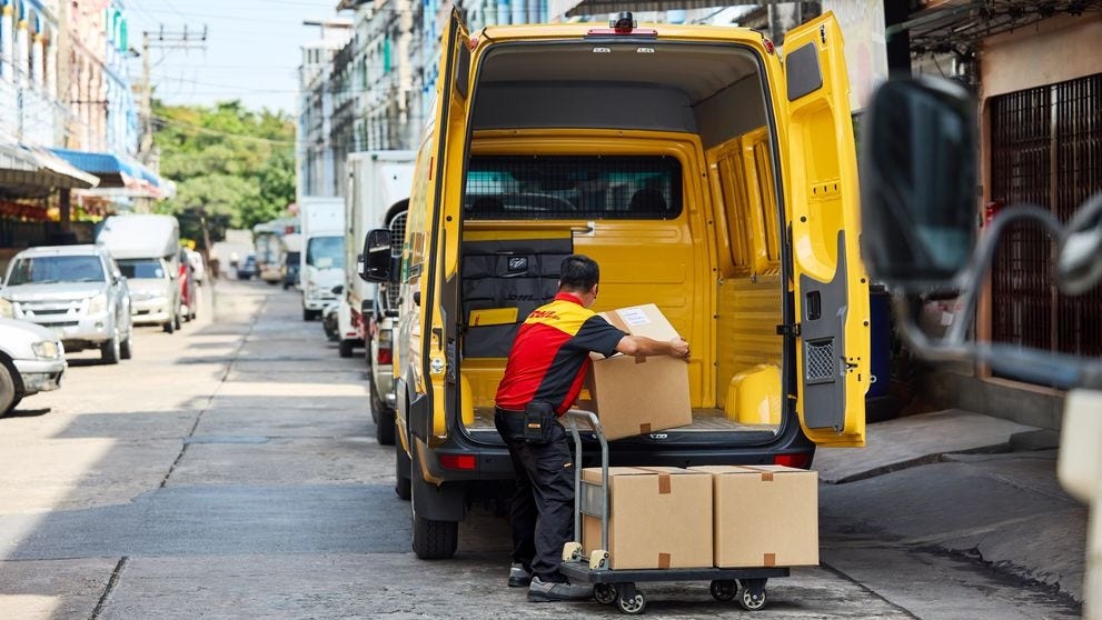 dhl express courier unloading food imports from van