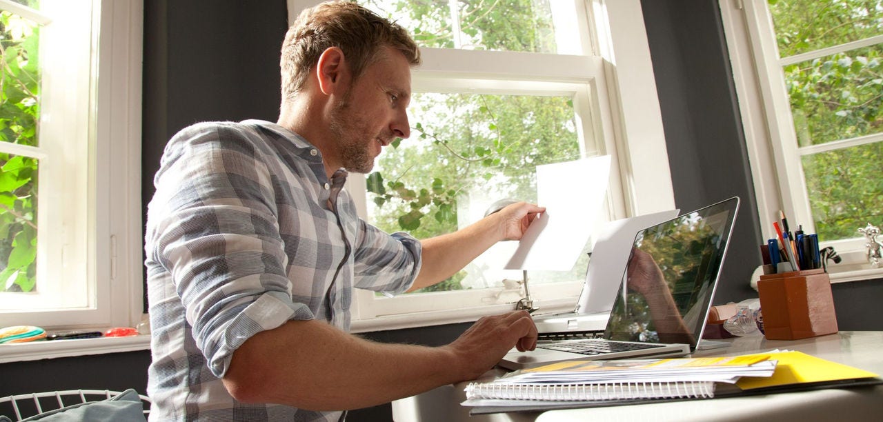 Entrepreneur working through documents in a home office while planning an import business
