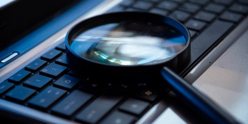 Magnifying glass on top of a keyboard