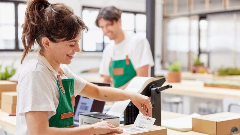 two business owners carefully packing foods to avoid shipping risks