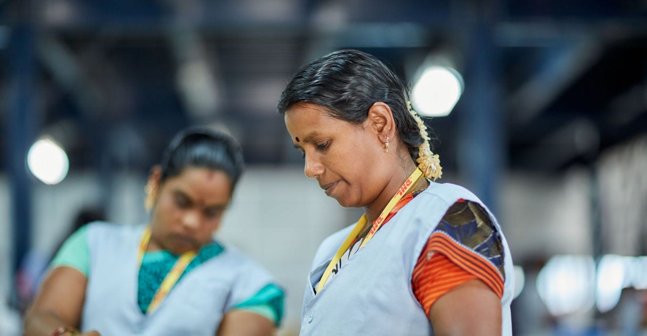 DHL employees sorting packages for international shipping to the UAE