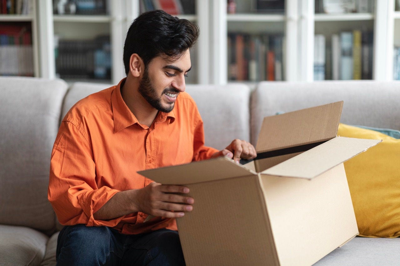 indian business reviewing a shipping box 