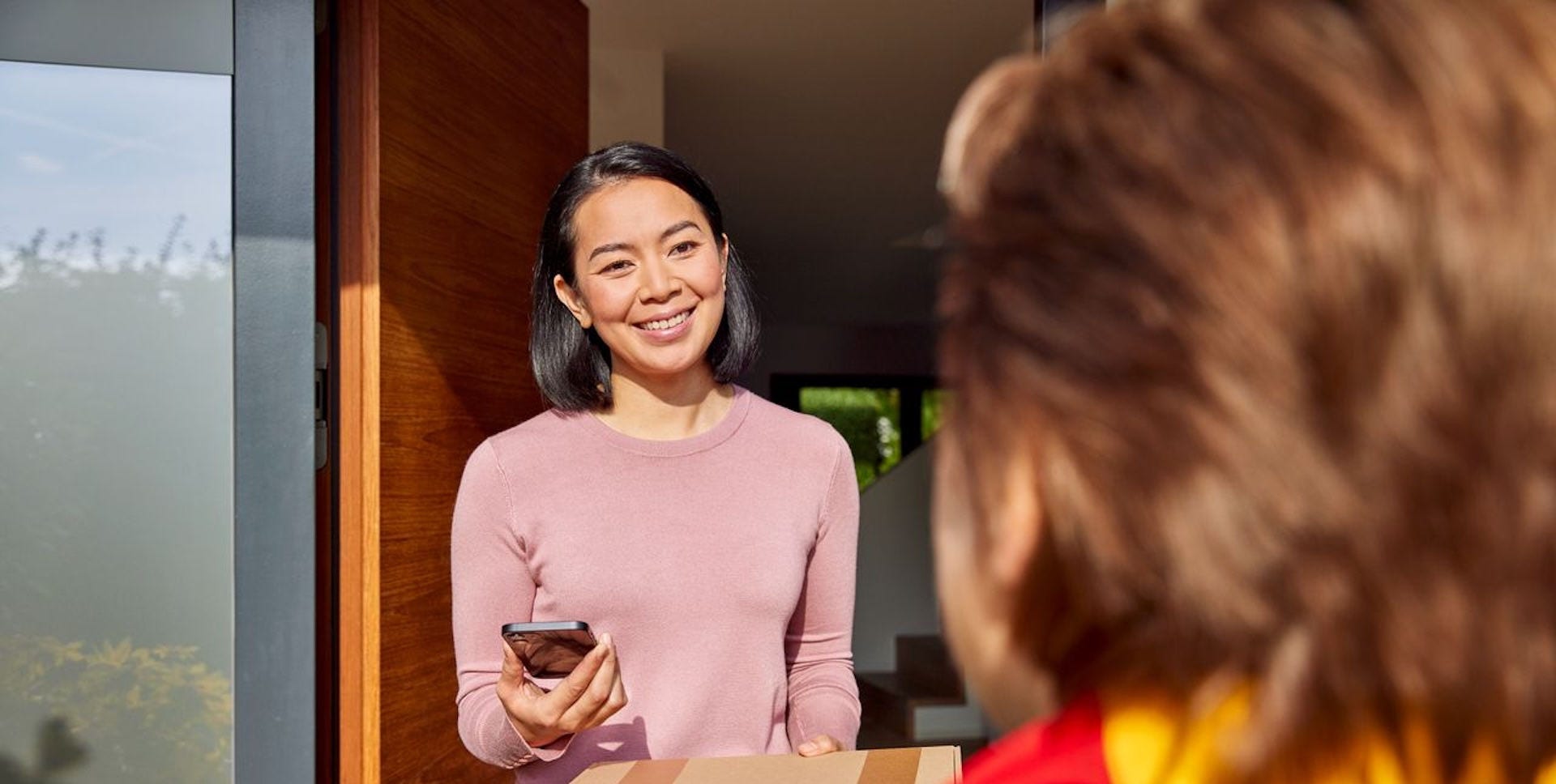 dhl express courier picking up a package from a customer