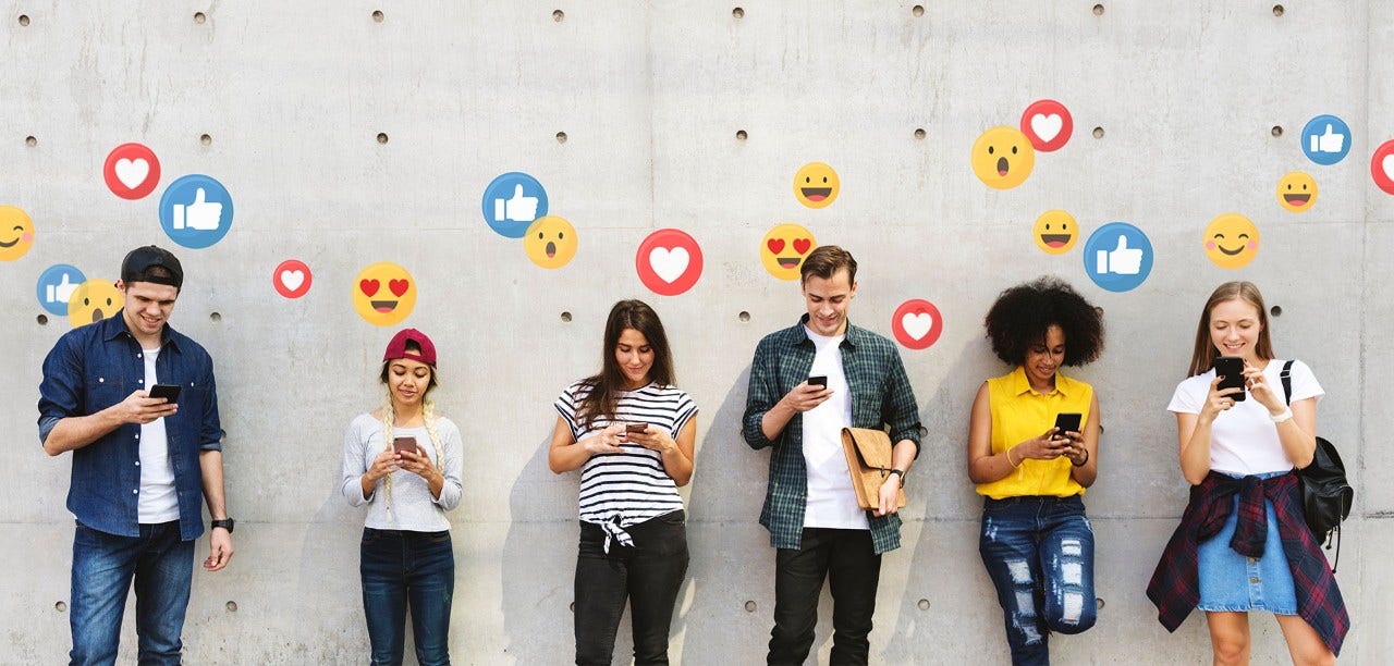youth leaning on a wall with emojis floating above them