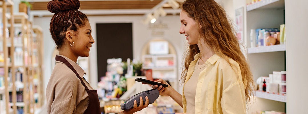 woman making a mobile payment in a shop