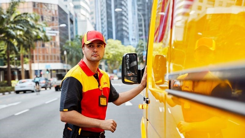 DHL logistics personnel delivering a parcel