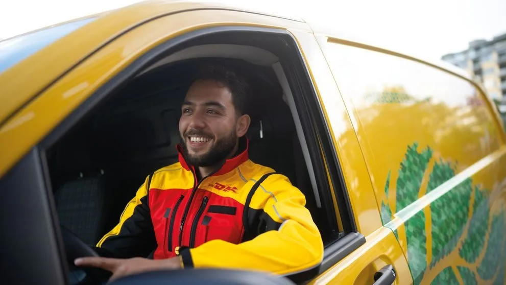 dhl express employee driving an electric van for import delivery