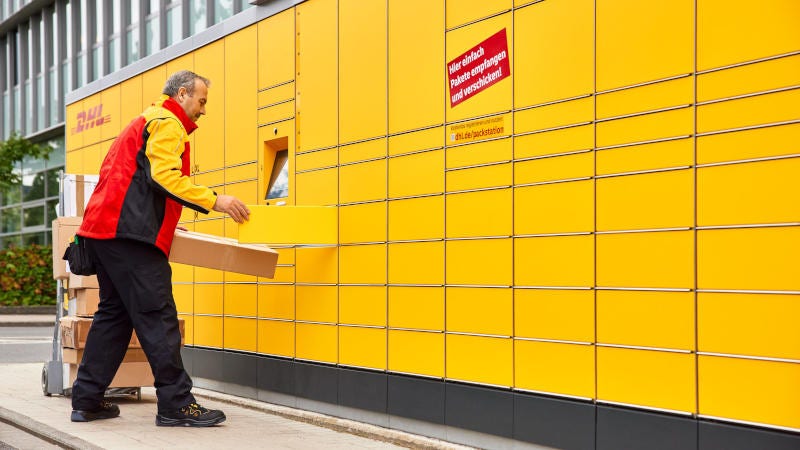 dhl express courier placing parcel in servicepoint locker