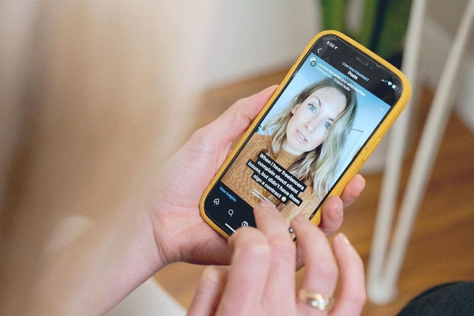 Close up of a woman using an iphone watching an instagram story