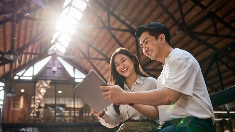 two individuals using a tablet to explore global markets for computer parts exports