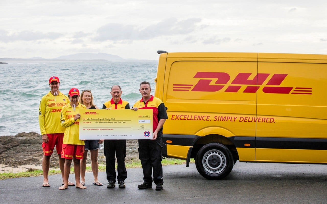 Jayme pictured with his mother Kaycee and father Nick, a patrol captain receiving the winning prize from DHL
